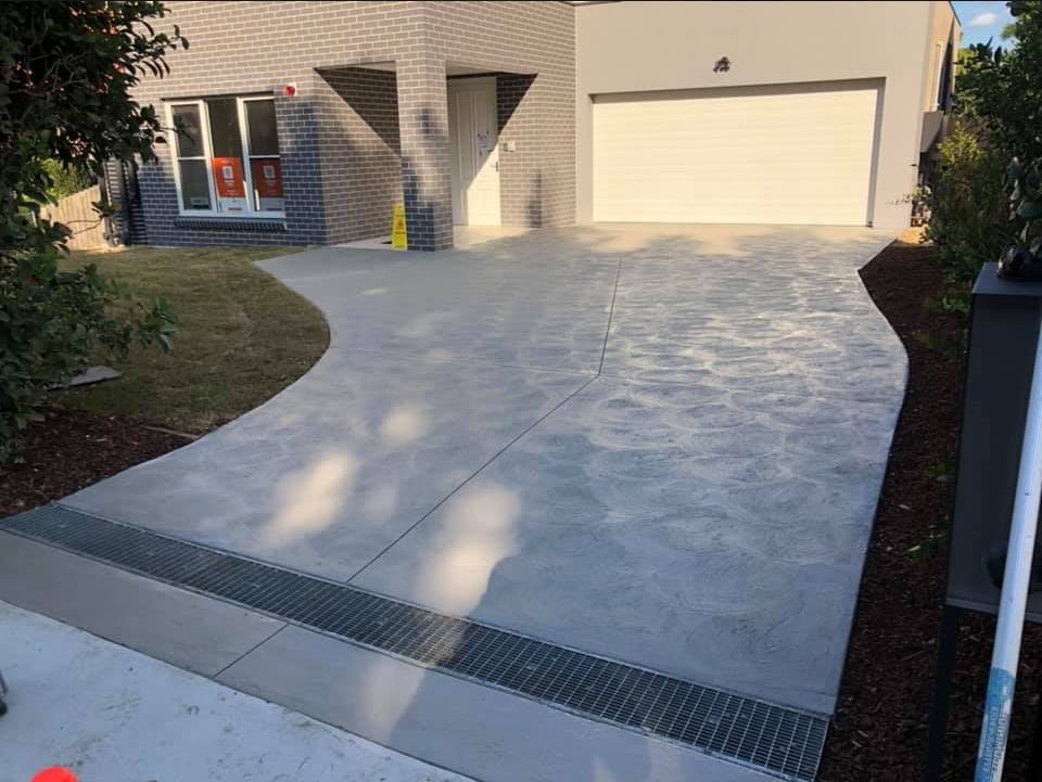 Broom finish driveway with strip drain